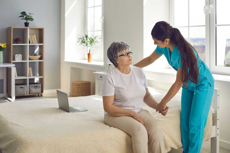 Older adult and family member reviewing advance care documents at a kitchen table with a medication list nearby
